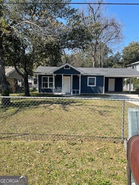 view of front of home with a carport, a front yard, and a fenced front yard