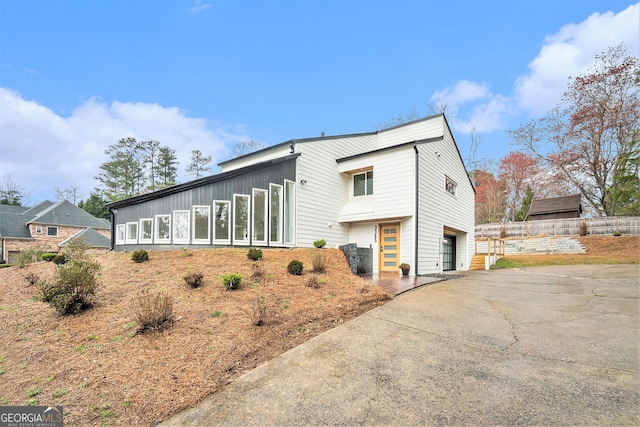 view of side of home featuring driveway