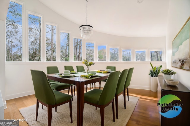 sunroom featuring lofted ceiling and an inviting chandelier