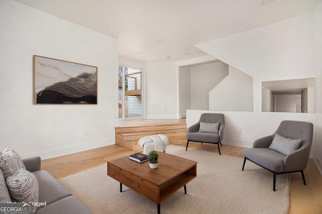 living area featuring baseboards and wood finished floors