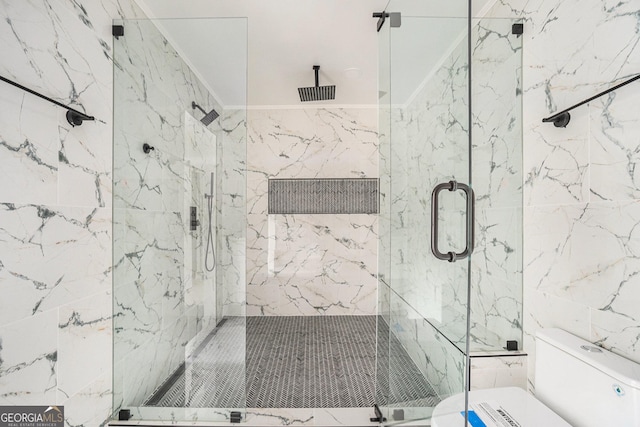 bathroom featuring tile walls, toilet, and a marble finish shower