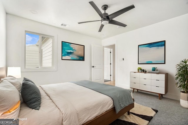 bedroom with baseboards, visible vents, a ceiling fan, and carpet