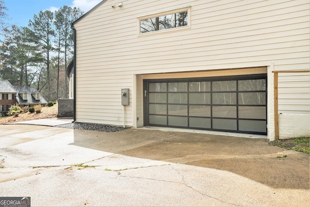 garage featuring concrete driveway