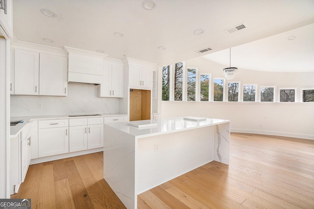 kitchen featuring visible vents, light wood-style floors, and black electric cooktop