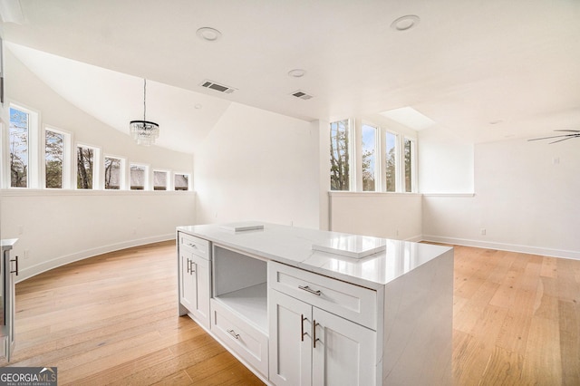 kitchen with a healthy amount of sunlight, visible vents, and light wood finished floors