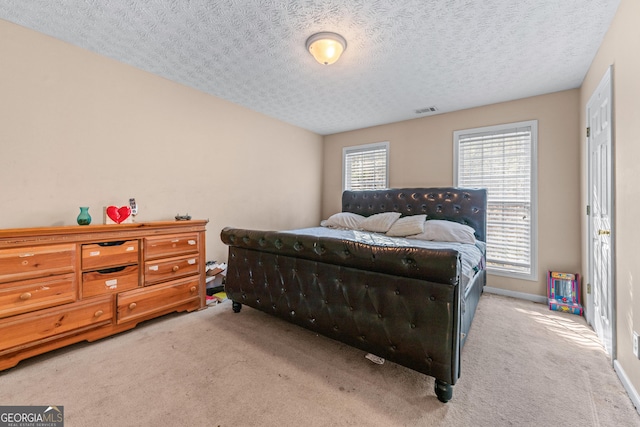 3920 Vine Gate Dr, Lithonia, GA 30038 - bedroom with carpet flooring, baseboards, visible vents, and a textured ceiling
