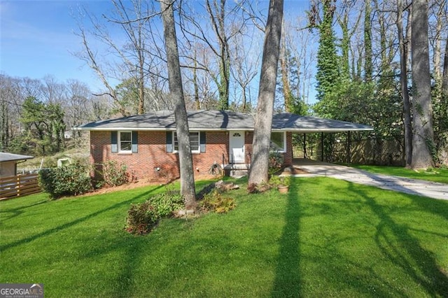 view of front of house with a front lawn, driveway, an attached carport, fence, and brick siding