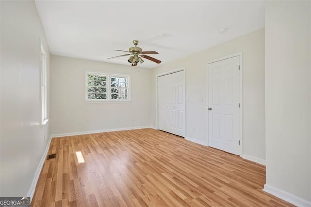 unfurnished bedroom with visible vents, baseboards, a ceiling fan, and light wood finished floors