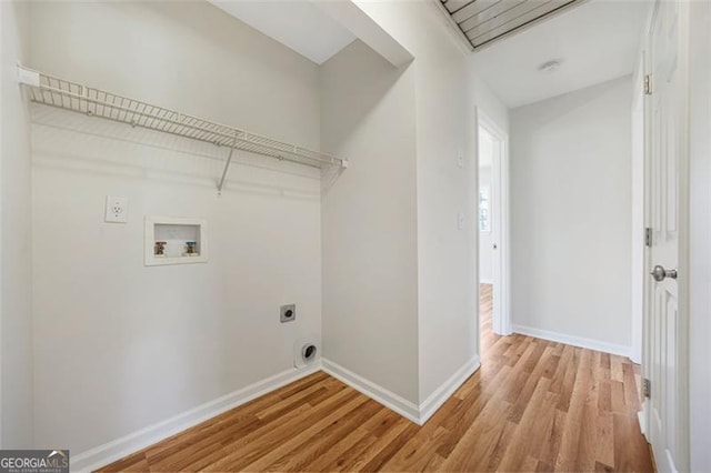 laundry area featuring electric dryer hookup, light wood-type flooring, baseboards, hookup for a washing machine, and laundry area