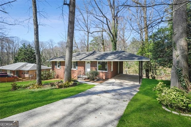 ranch-style house featuring an attached carport, concrete driveway, brick siding, and a front yard