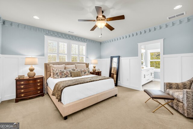 bedroom featuring recessed lighting, visible vents, light colored carpet, and wainscoting