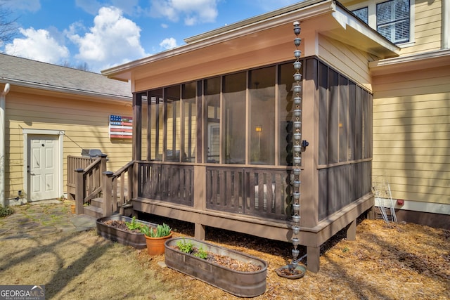 wooden terrace featuring a sunroom