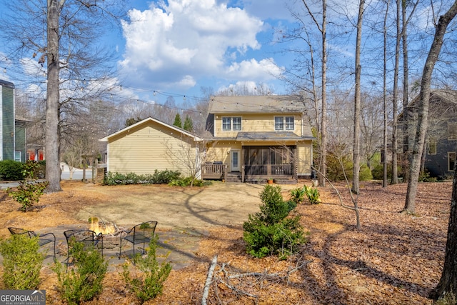 rear view of property with a wooden deck