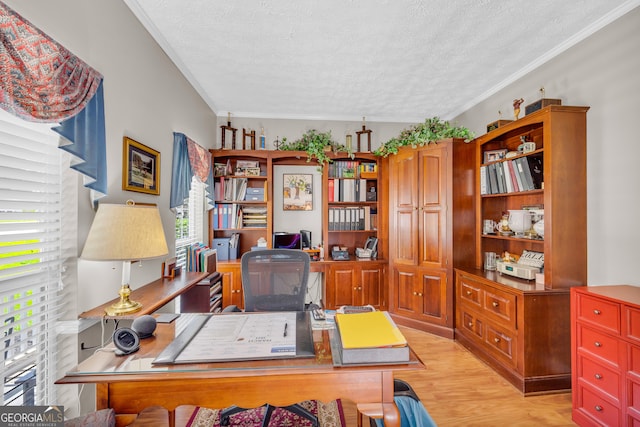 office featuring light wood-style flooring, a textured ceiling, and ornamental molding