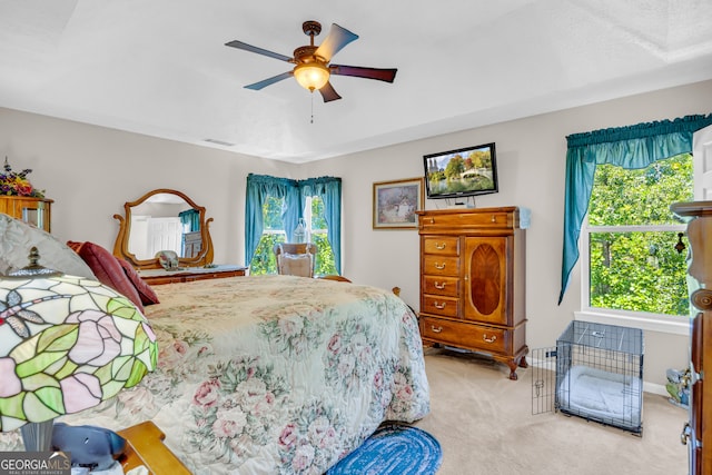 carpeted bedroom with visible vents, baseboards, and ceiling fan