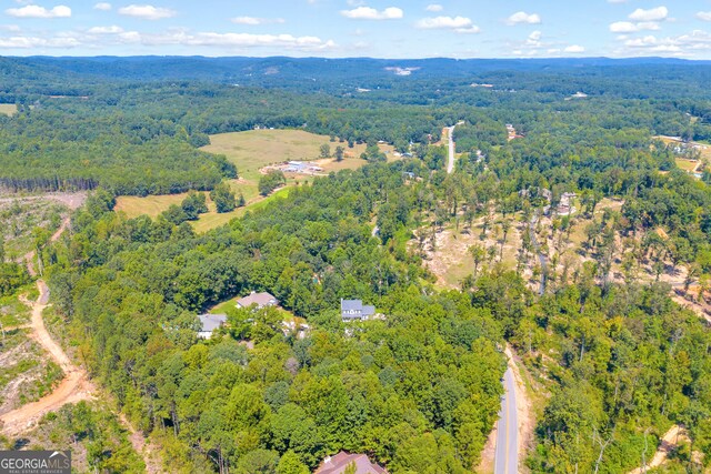 birds eye view of property featuring a view of trees