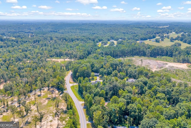 birds eye view of property featuring a view of trees