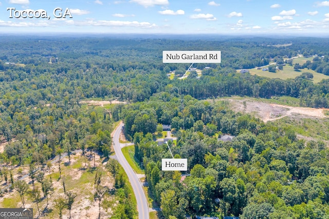 drone / aerial view featuring a forest view