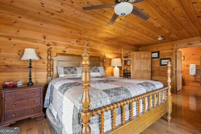 bedroom featuring wooden walls, wood ceiling, and wood finished floors