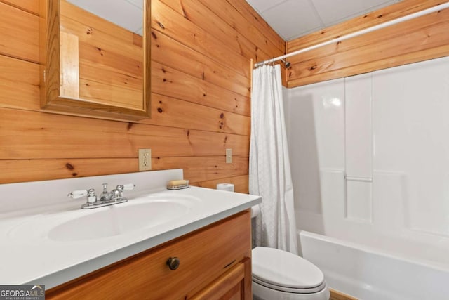 full bathroom featuring shower / bathtub combination with curtain, vanity, toilet, and wooden walls