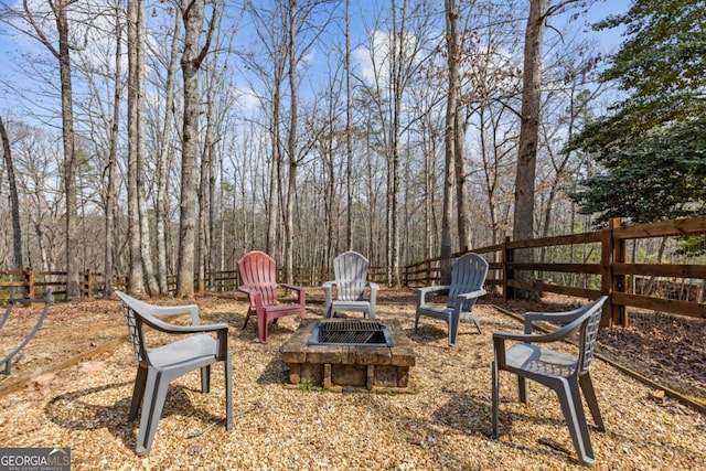 view of yard with a fire pit and fence