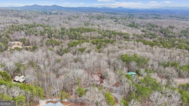 aerial view featuring a forest view and a mountain view