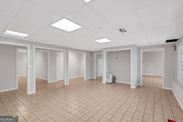 1139 Tennyson Pl NE, Brookhaven, GA 30319 - below grade area featuring a drop ceiling and baseboards