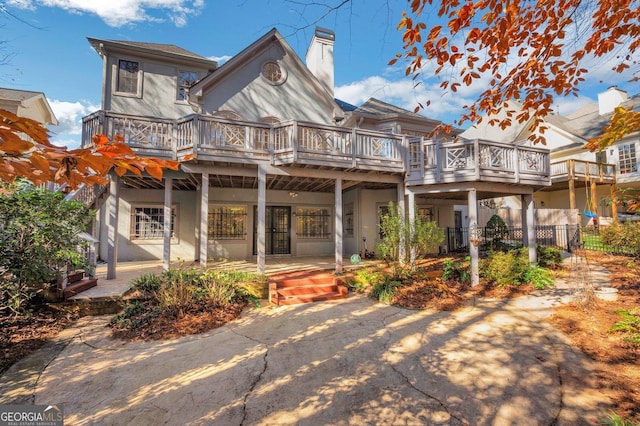 1139 Tennyson Pl NE, Brookhaven, GA 30319 - back of house featuring a chimney and a wooden deck