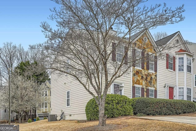 view of side of home featuring central AC unit