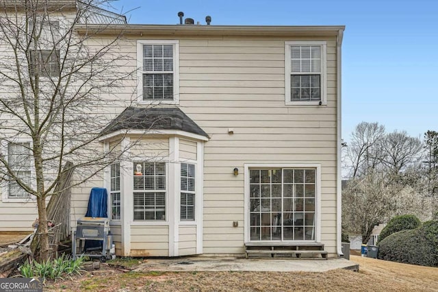 back of property featuring entry steps