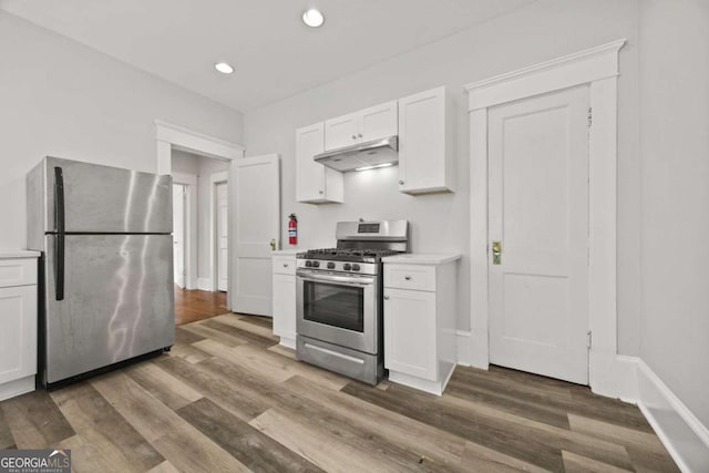 1769 Lyle Ave, Atlanta, GA 30337 - kitchen featuring stainless steel appliances, under cabinet range hood, white cabinetry, light countertops, and recessed lighting