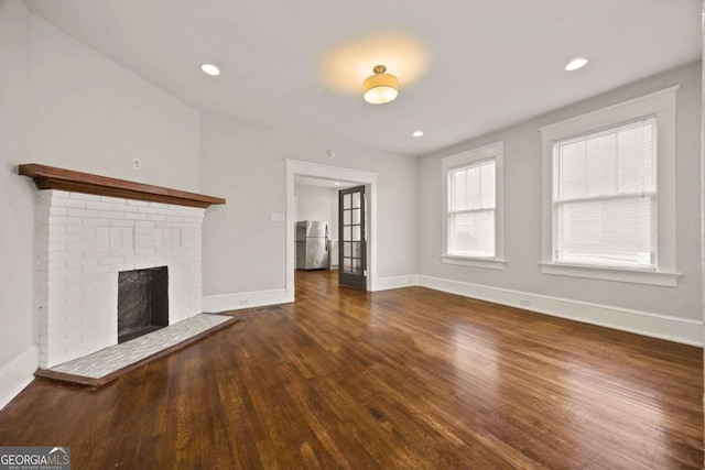 1769 Lyle Ave, Atlanta, GA 30337 - unfurnished living room with wood finished floors, a fireplace, and recessed lighting