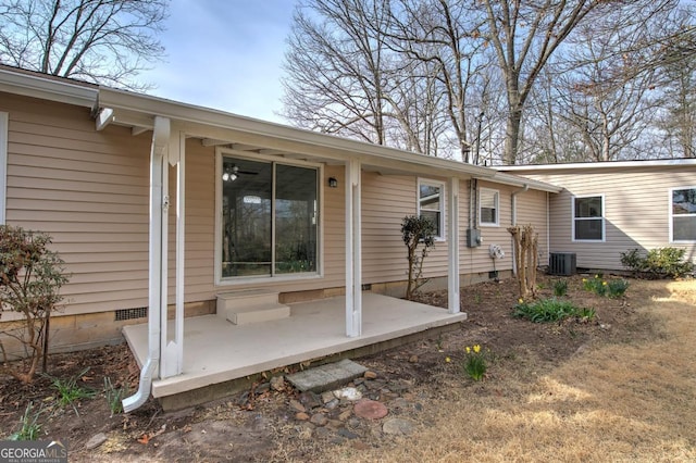 view of exterior entry featuring crawl space, a patio, and central AC unit