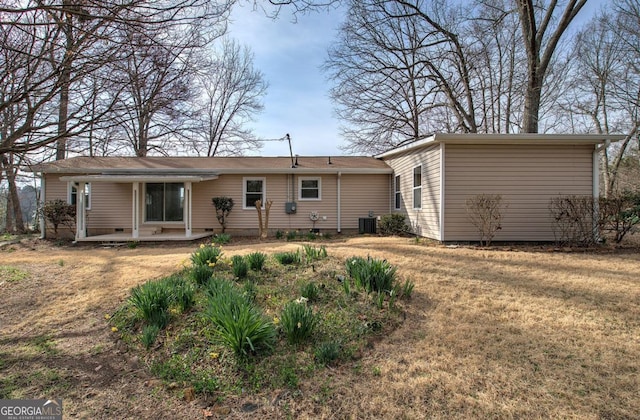 rear view of house with crawl space, a lawn, and central AC