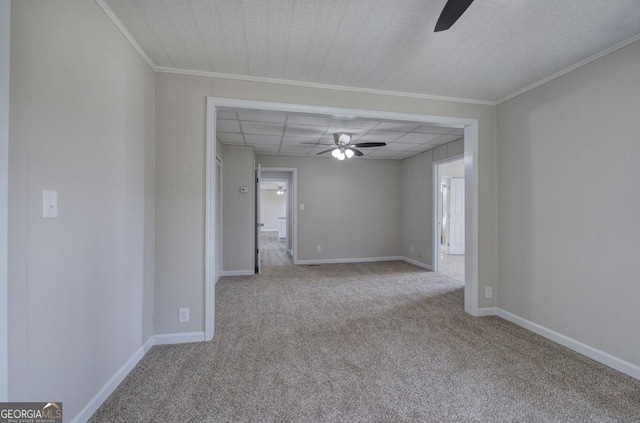 empty room featuring baseboards, carpet, and a ceiling fan