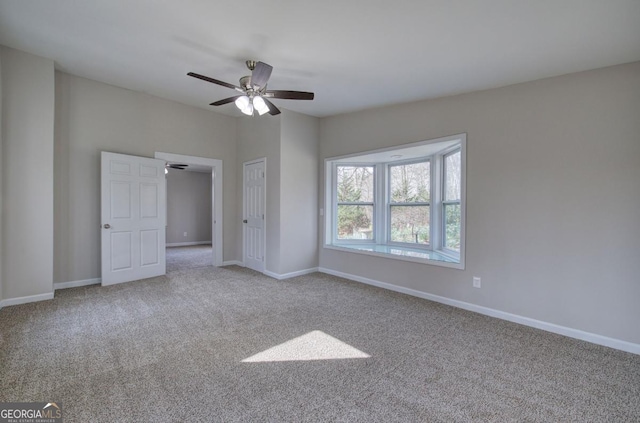 unfurnished bedroom with baseboards, carpet floors, and ceiling fan