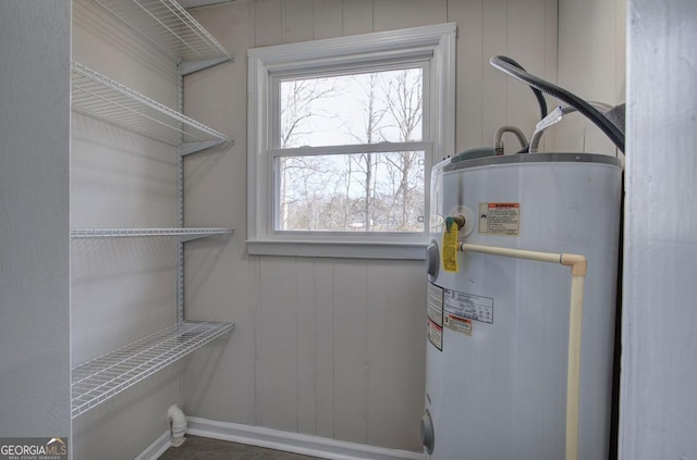 interior space with laundry area and electric water heater