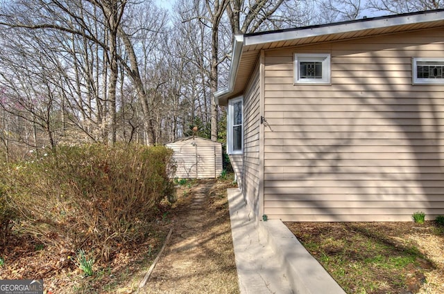 view of home's exterior featuring a storage shed and an outdoor structure