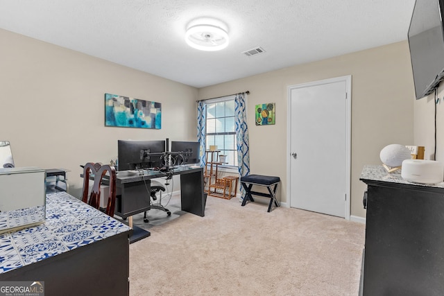 office featuring visible vents, carpet flooring, a textured ceiling, and baseboards