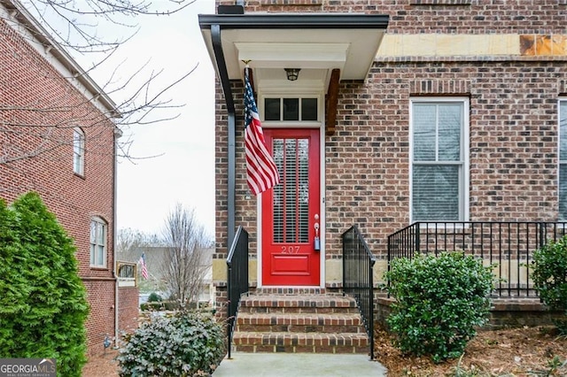 view of exterior entry with brick siding