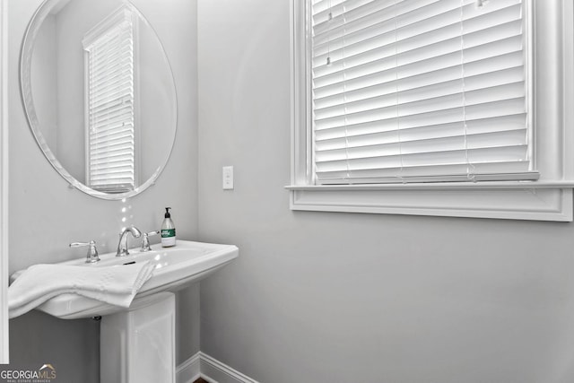 bathroom with baseboards and a sink