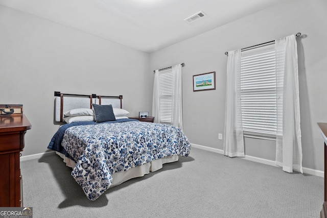 bedroom with visible vents, baseboards, and carpet