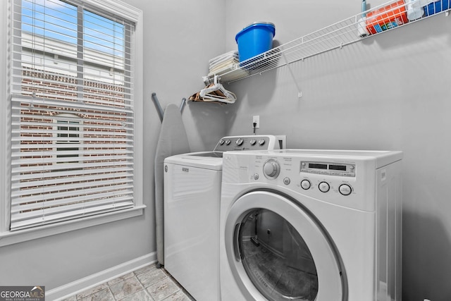 laundry room featuring washer and dryer, laundry area, and baseboards