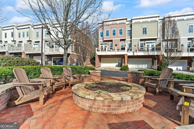 view of patio / terrace with a garage and a residential view