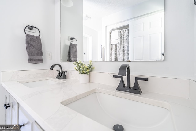 bathroom featuring double vanity and a sink