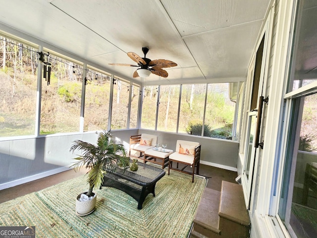 sunroom featuring ceiling fan