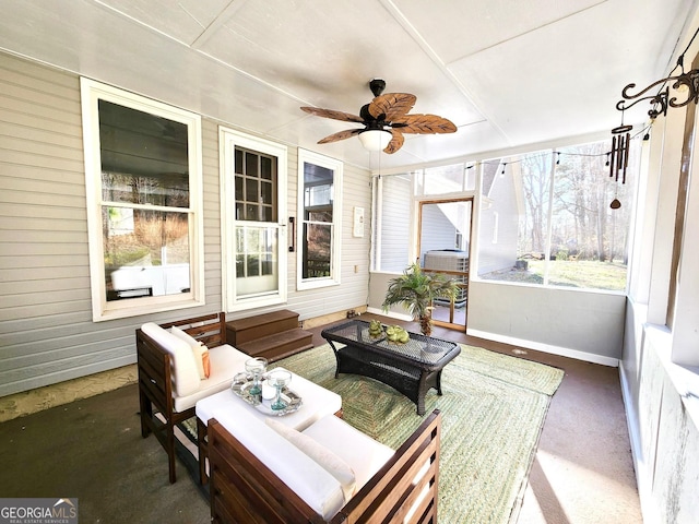 sunroom / solarium featuring ceiling fan