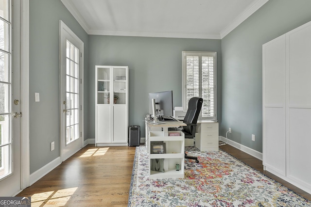 office space with wood finished floors, baseboards, and ornamental molding