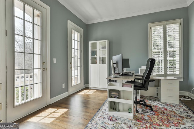 office space with crown molding, baseboards, and wood finished floors