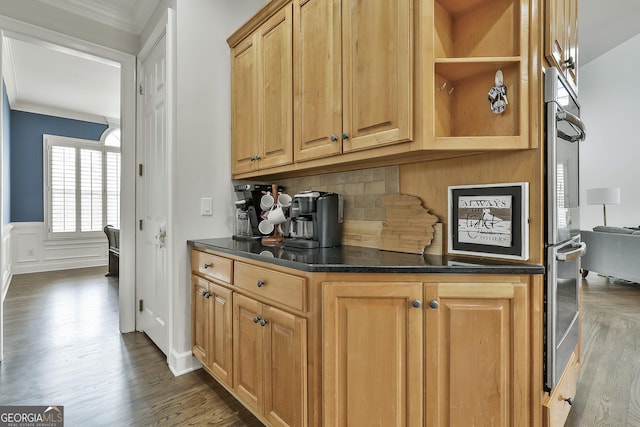 kitchen featuring dark wood-style floors, a wainscoted wall, ornamental molding, a decorative wall, and tasteful backsplash